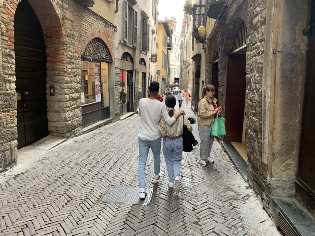 Alt Soufiane and his girlfriend Rachele walking through Città Alta streets, in Bergamo. Here, they both study Planning and Management of Tourism Systems at Bergamo University.